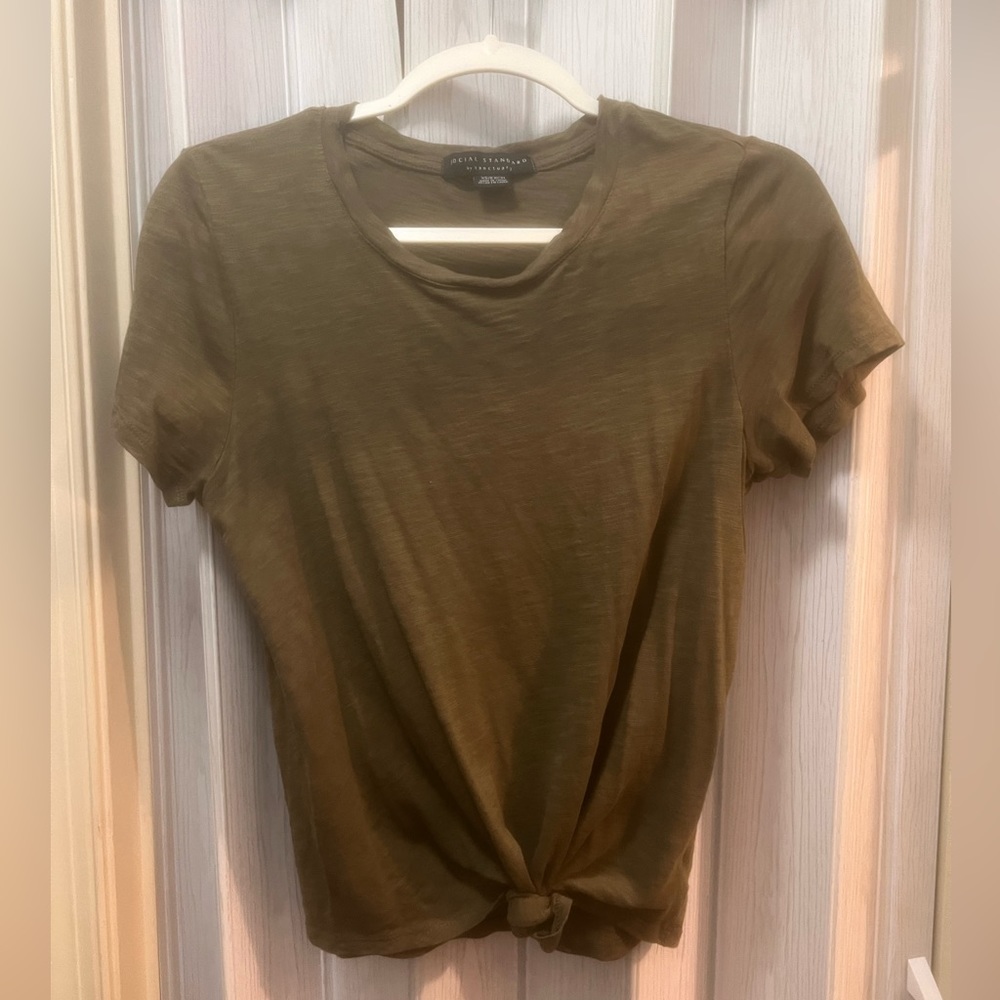 Army green colored tee shirt (short sleeves). Knotted at the bottom.